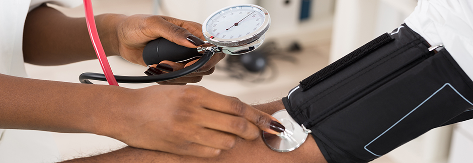 A physician measures a patient's blood pressure.