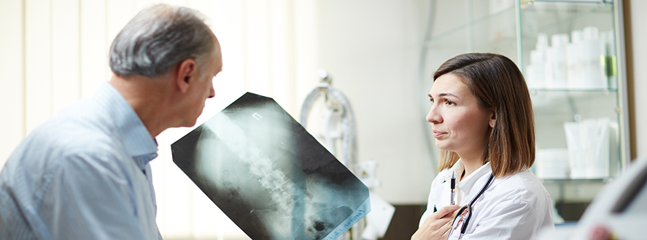 A patient and orthopedic surgeon discussing a scan.