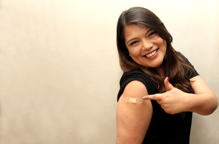 40-year-old Latin woman happy and scared with the Covid-19 vaccine shot