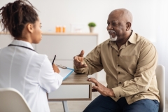 man visiting doctor telling about health